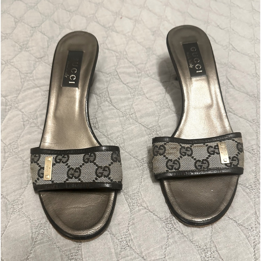 Gucci slip-on sandals. They have a classic open-toe design with a low heel.